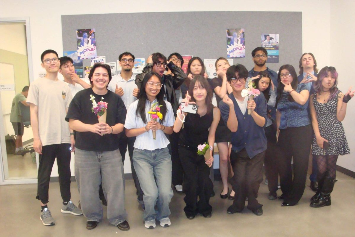 The #Include cohort posing with flowers at Demo Day